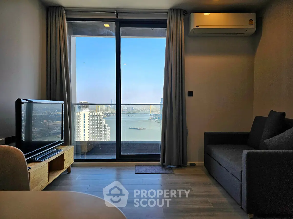 Modern living room with stunning city and river view from large window.