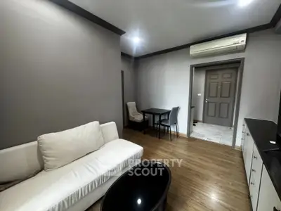 Modern living room with sleek furniture and air conditioning in a stylish apartment.