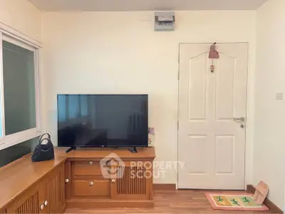 Cozy living room with wooden furniture and modern TV setup
