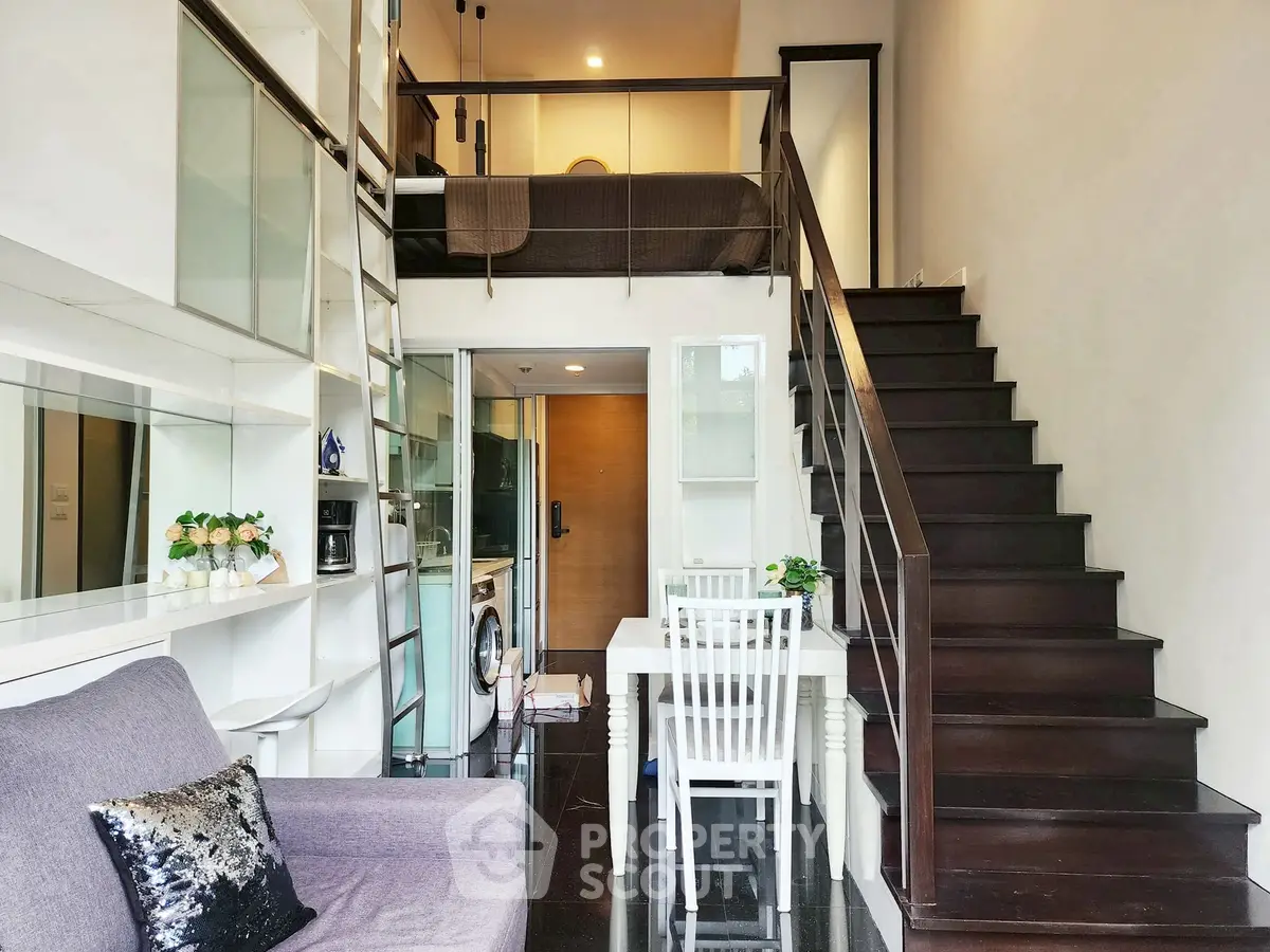 Modern loft apartment with stylish staircase and cozy living area