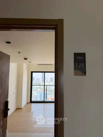 Spacious apartment with city view and elegant wooden flooring, perfect for modern living.