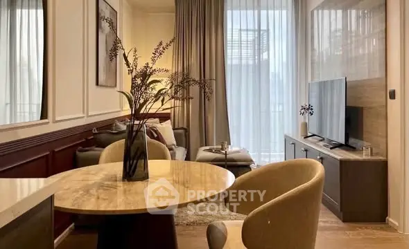 Elegant living room with modern decor, large TV, and stylish furniture, perfect for relaxation and entertainment.