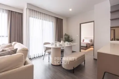 Modern living room with elegant dining area and cozy bedroom view