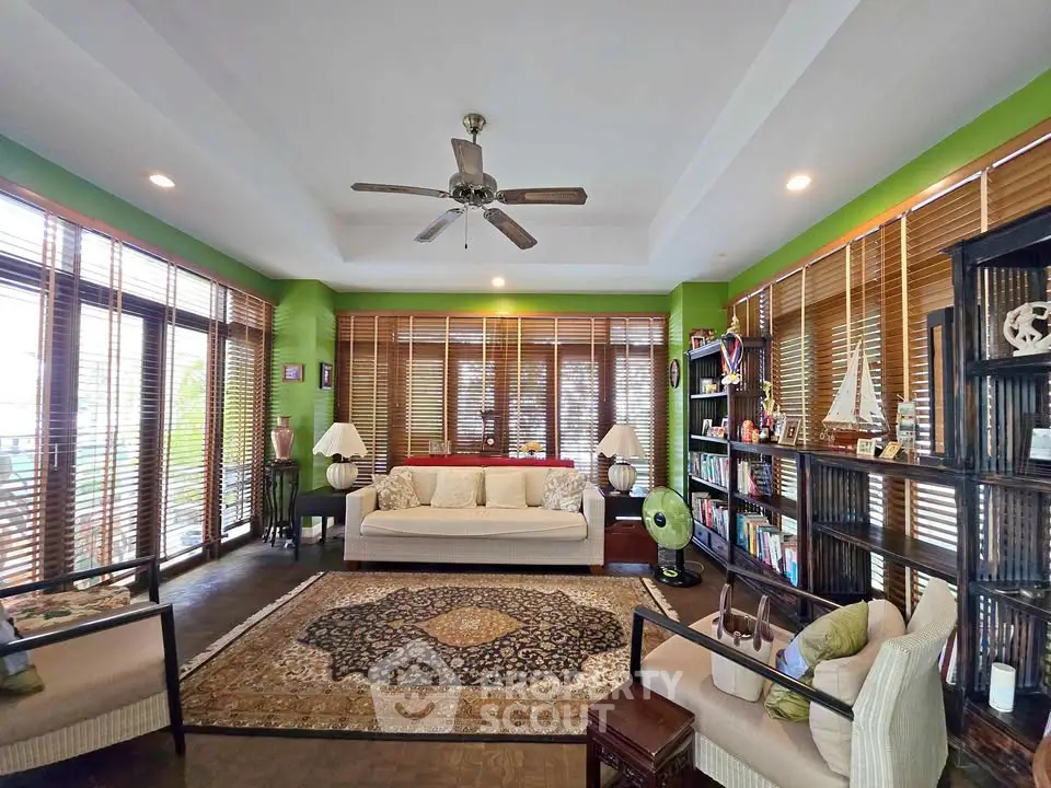 Spacious living room with elegant decor and large windows offering natural light.