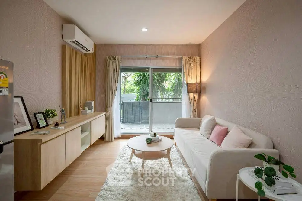Charming living room with cozy decor and garden view, perfect for relaxation.