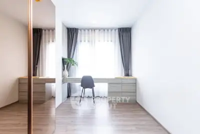 Minimalist study room with sleek desk and modern chair, flooded with natural light from large window.