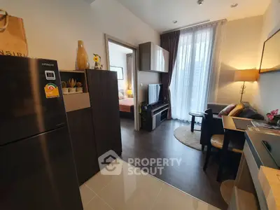 Modern apartment interior with open layout, featuring a cozy living area and stylish kitchen.