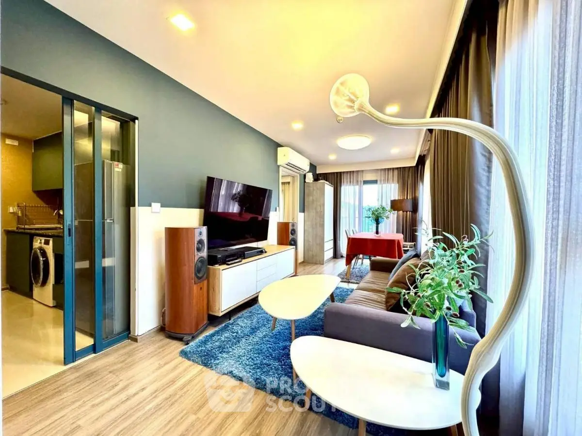 Modern living room with stylish decor and open layout, featuring a cozy seating area and entertainment center.
