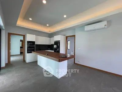 Modern kitchen with island and sleek appliances in open layout design