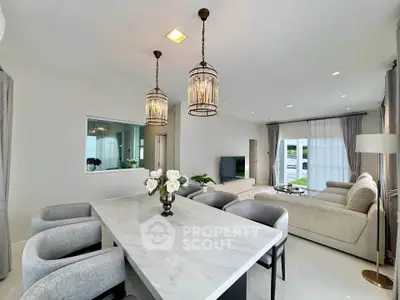 Elegant open-plan living room with chic dining area and modern decor