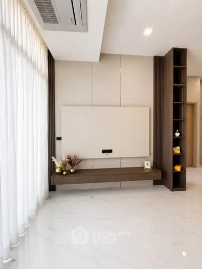 Elegant modern living room with sleek design and floor-to-ceiling windows