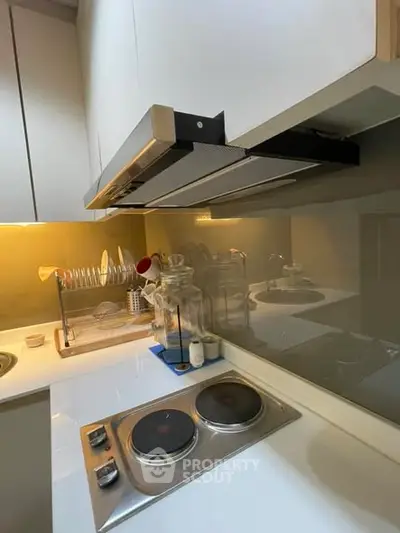 Modern kitchen with sleek stovetop and efficient storage solutions.