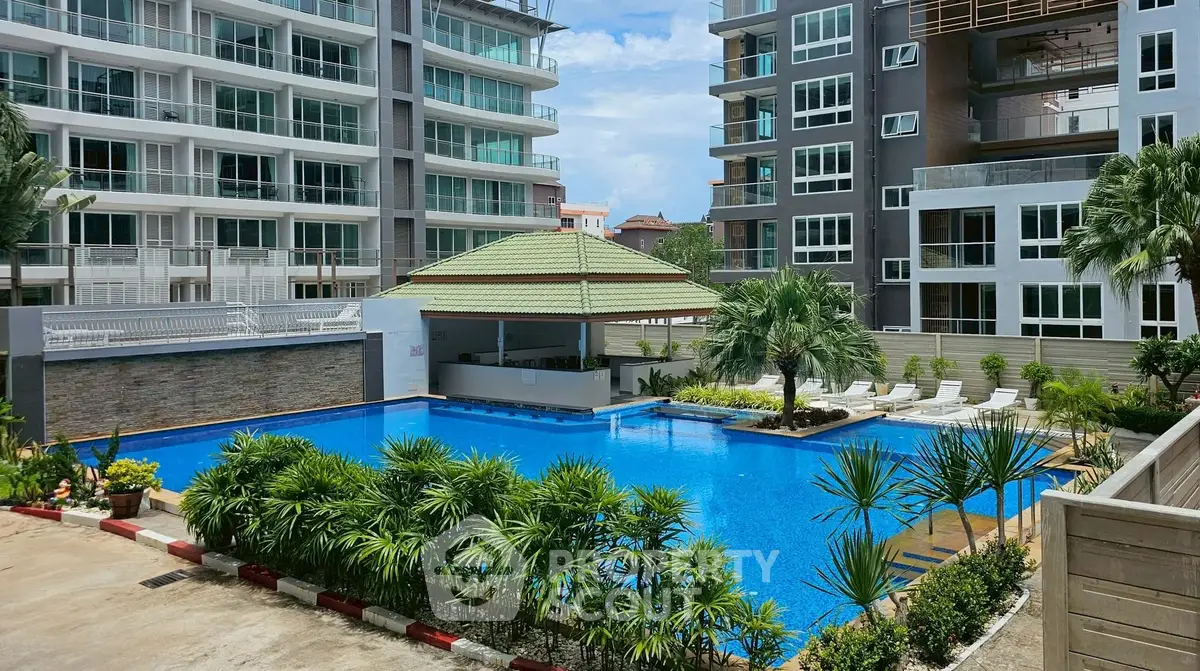 Luxurious apartment complex with stunning pool and lush landscaping.