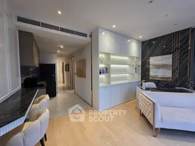 Modern living room with sleek design and open layout, featuring elegant furniture and stylish decor.