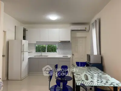 Modern kitchen with sleek white cabinets and stylish dining area