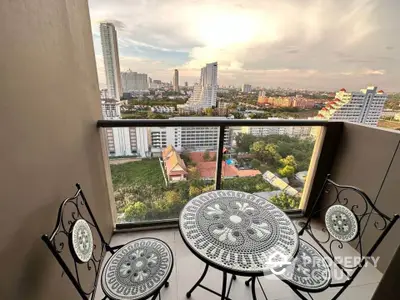 Stunning high-rise balcony with panoramic city views and elegant outdoor furniture.