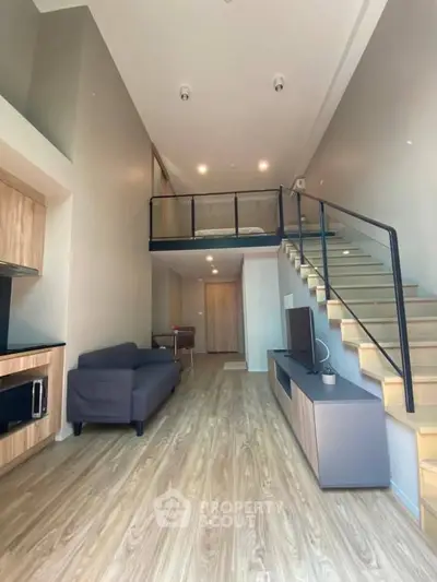 Modern loft apartment with mezzanine, sleek staircase, and stylish living area