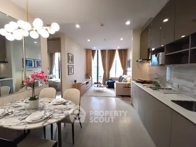 Modern open-layout living room and kitchen with elegant decor and natural light