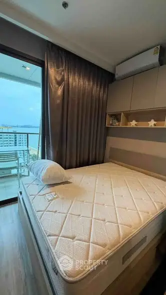 Modern bedroom with balcony view in high-rise apartment