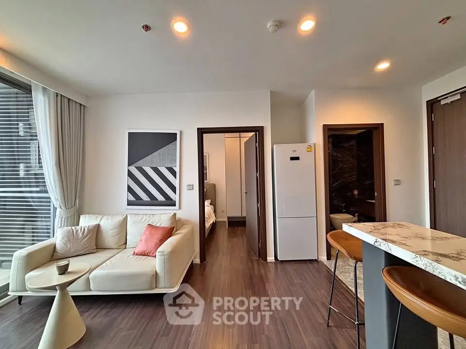 Modern living room with stylish decor and open kitchen layout in a contemporary apartment.