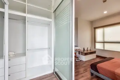 Spacious bedroom with walk-in closet and modern decor