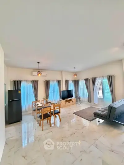 Spacious modern living room with dining area and large windows, featuring elegant marble flooring.