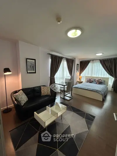 Modern studio apartment with cozy living area and stylish decor
