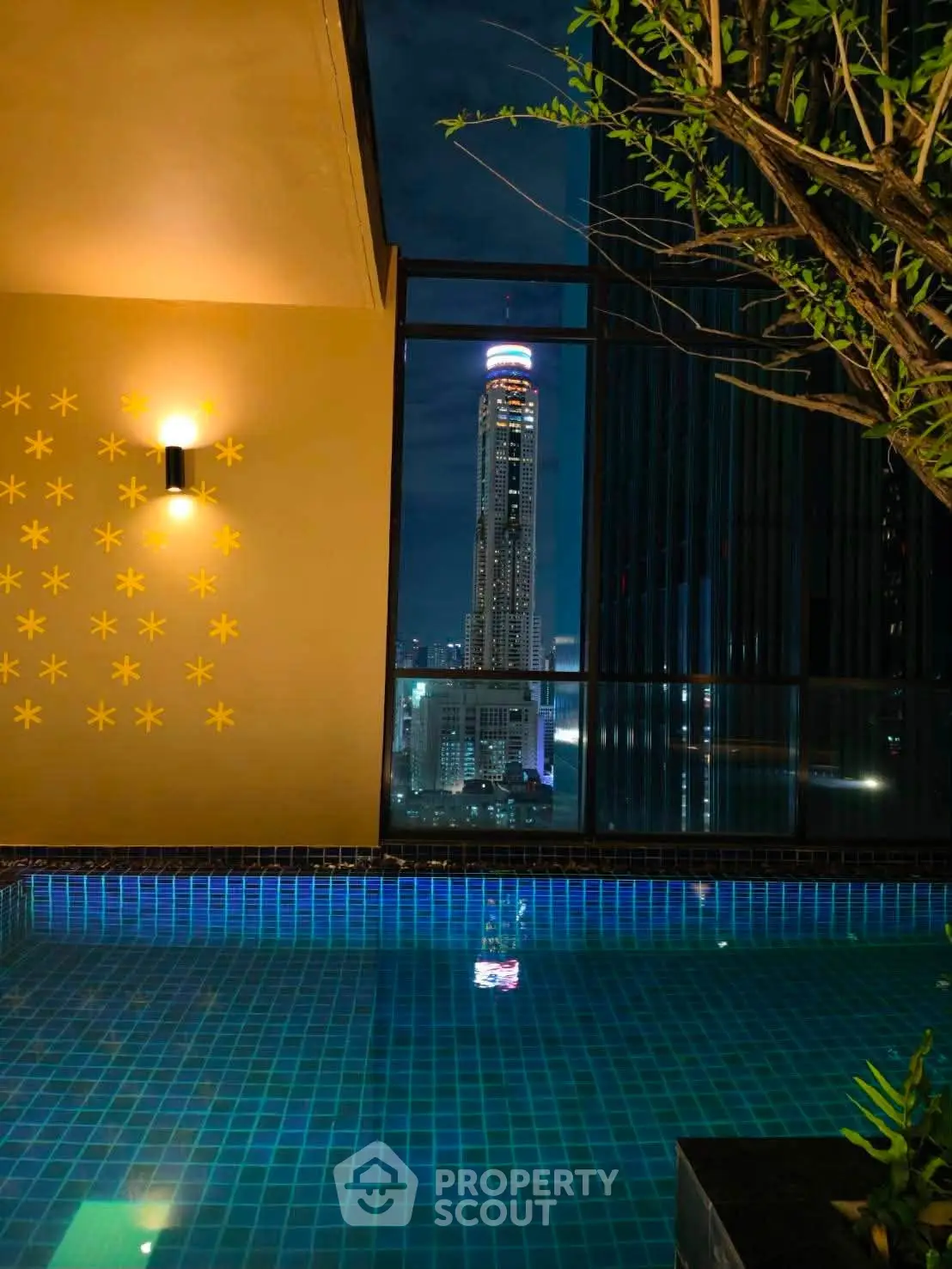 Luxurious rooftop pool with stunning city skyline view at night
