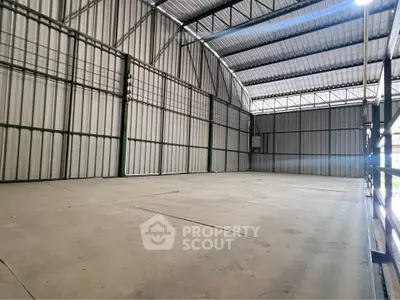 Spacious industrial warehouse with high ceilings and ample storage space.