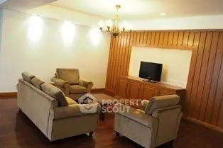 Elegant living room with plush sofas and wooden paneling