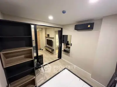 Modern study room with sleek furniture and air conditioning in a contemporary apartment.