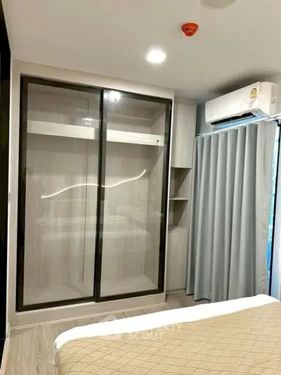 Modern bedroom with sleek wardrobe and air conditioning unit
