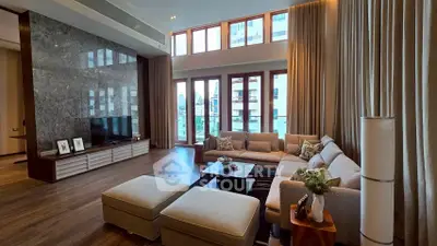 Spacious modern living room with high ceilings and large windows