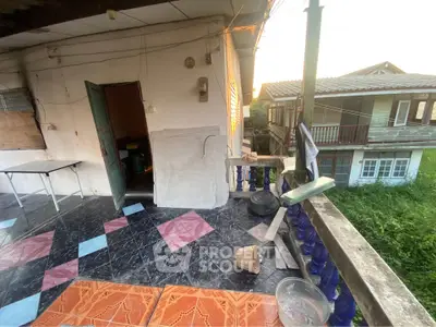 Charming rustic balcony with colorful tiles and countryside view, perfect for relaxation.