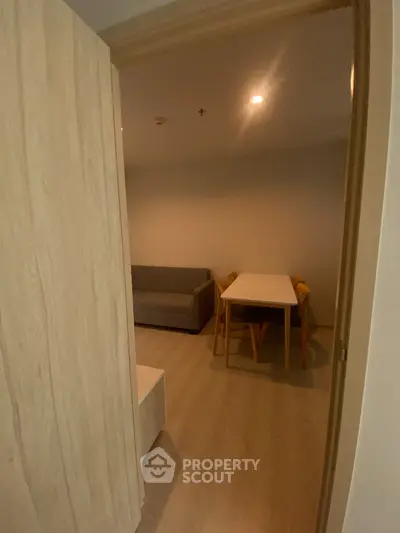 Cozy interior with wooden flooring and modern furniture, perfect for a compact living space.