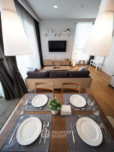 Modern living room with elegant dining setup and cozy seating area