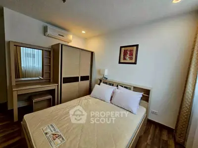 Cozy bedroom with modern furniture and air conditioning, perfect for relaxation and comfort.