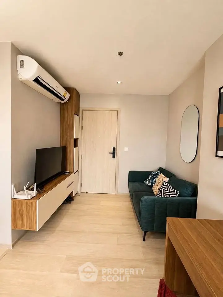 Modern living room with stylish furniture and wall-mounted TV, featuring a cozy sofa and elegant decor.