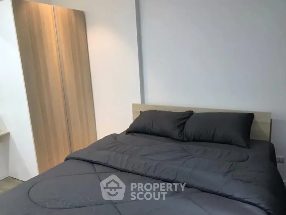 Modern bedroom with sleek wooden wardrobe and cozy bedding