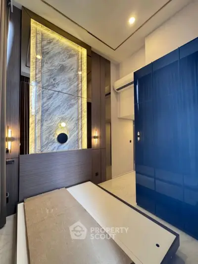 Luxurious modern bedroom with elegant wall design and sleek blue wardrobe