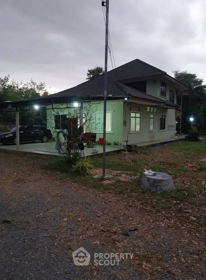 Charming two-story house with spacious yard and carport, perfect for family living in a serene neighborhood.