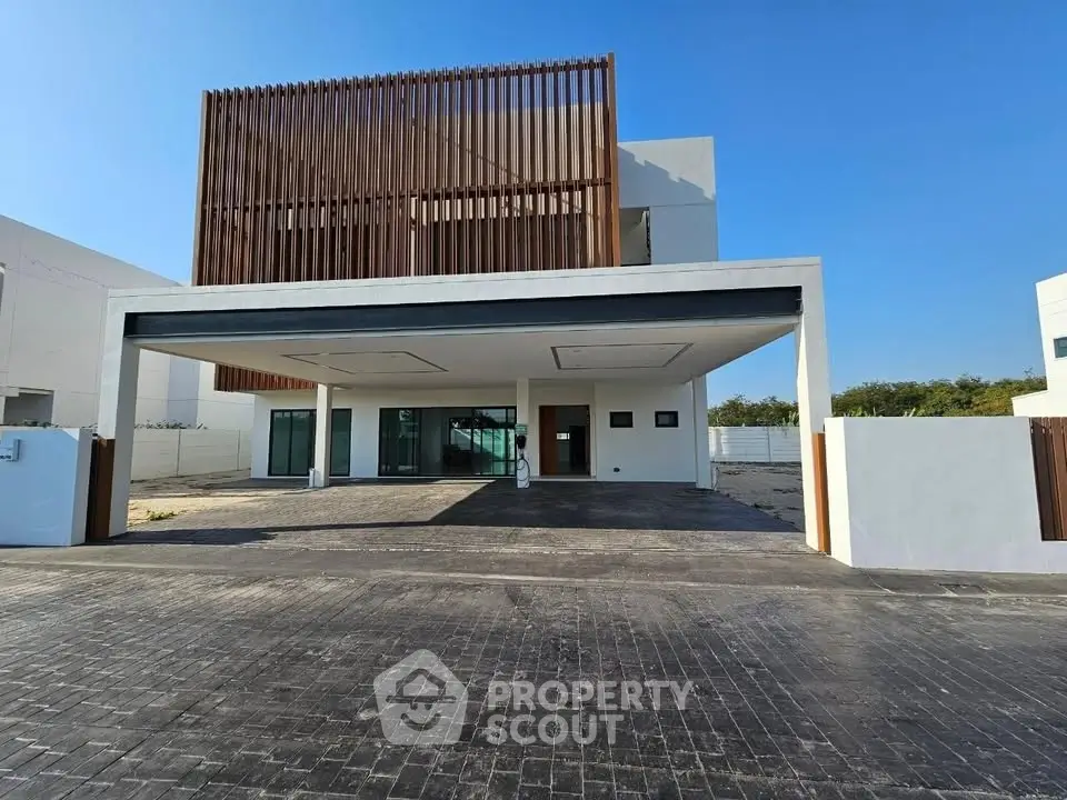 Modern architectural home with sleek design and spacious driveway, perfect for luxury living.