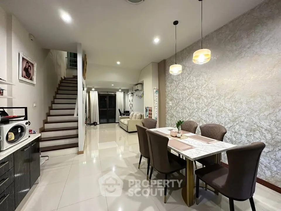 Spacious modern dining area with elegant lighting and open layout