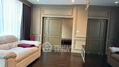 Luxurious living room with elegant paneling and plush seating, perfect for relaxation and entertaining.