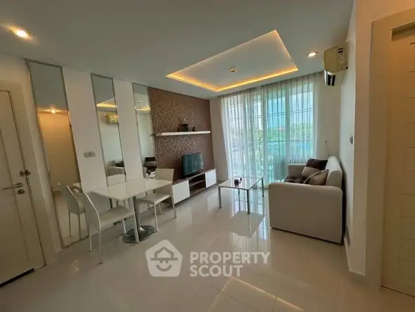 Modern living room with sleek design, featuring a cozy sofa, TV, and elegant dining area.