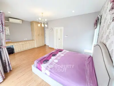 Spacious bedroom with elegant decor and ample natural light