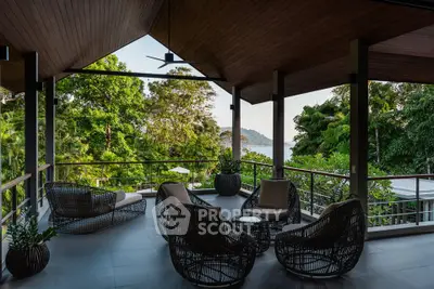 Stunning outdoor terrace with lush greenery and ocean view, perfect for relaxation and entertaining.