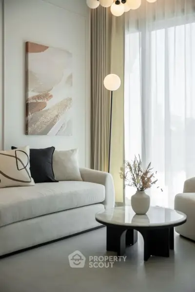 Elegant living room with modern decor, featuring plush sofas, chic lighting, and a stylish coffee table.