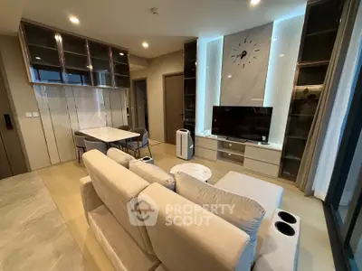Modern living room with stylish furniture and built-in entertainment center