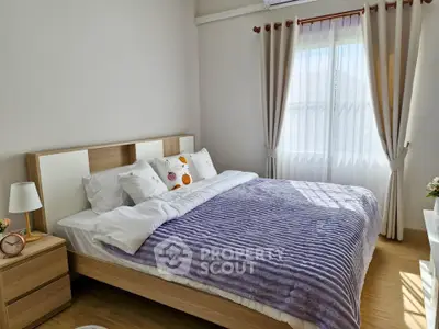 Cozy bedroom with natural light and modern decor